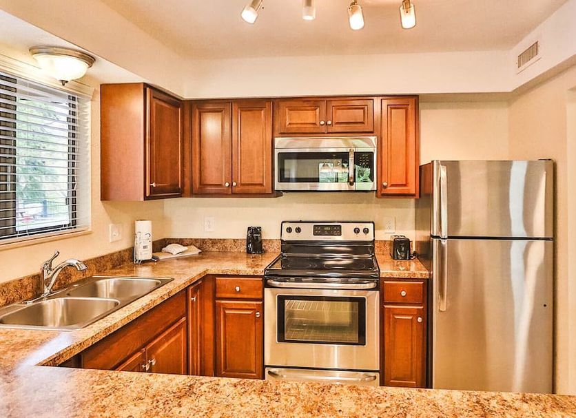 Laurel Point Resort Gatlinburg kitchen with stainless steel appliances and wood cabinets