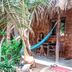 Naif Rustic & Ecologic Lodge in Máncora with a hammock on a rustic wooden bungalow porch