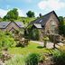 Tudor Farmhouse in Coleford with stone cottages, garden seating, and lush countryside hillside