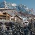 Aman Rosa Alpina in Badia/Abtei with snowy alpine chalets and dramatic mountain peaks