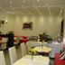 Cityhotel Ahlen Garni in Ahlen dining room with tables, chairs, buffet counter and striped window blind