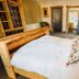 The Inn at Kippen in Stirling, cozy guest room with wooden bed frame and adjoining bathroom doors