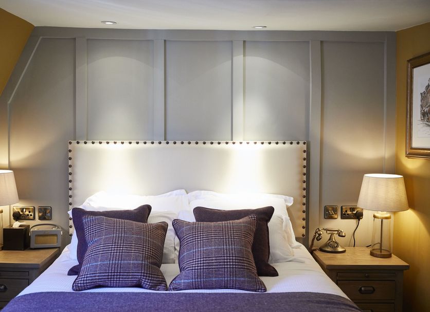 Wykeham Arms Winchester bedroom with double bed, bedside lamps and paneled wall