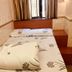 New Style Guest House room in Hong Kong with a bed, window curtains and wooden side ledge