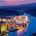 Grand Canyon West Hotel Sheps Miners Inn in Chloride with city lights and waterfront harbor at dusk