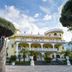 Villa Le Zagare Relais & Spa in Gragnano, ornate yellow hotel facade with arched balconies and entrance sign