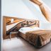 Arensburg Boutique Hotel & Spa in Kuressaare: bright attic bedroom with sloped ceiling and draped canopy over bed