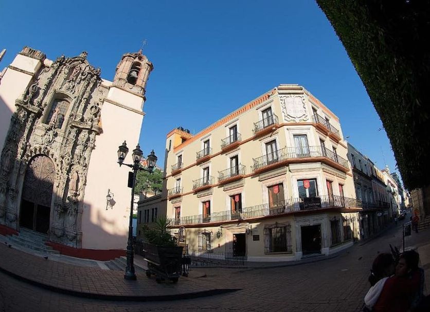 Hotel San Diego in Guanajuato, exterior view of historic building beside ornate church under blue sky