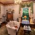 1899 Wright Inn & Carriage House in Asheville parlor with chandelier, lace tables, and bay windows