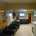 Lahinch Hostel in Lahinch lounge with black leather seating and wall-mounted TV