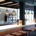 Hotel Bieze in Borger bar with hanging pendant lights, high counter stools, and bottle display