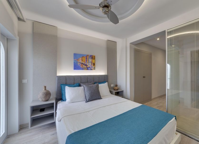 La Brezza Suite & Hotel Bodrum bedroom with king bed, glass partition and ceiling fan