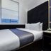 The Z Hotel Holborn, London compact guest room with single bed, window and bedside desk