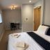 Deepcut Lodge Bed & Breakfast Self Service in Camberley: compact guest room with bed, desk and windows