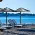 Sunrise Hotel in Pefki: beachfront lounge chairs and straw umbrellas by the sea