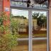 Hosteria Maryland in Posadas entrance with glass doors and potted plants
