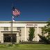 Hampton Inn South Haven exterior with American flags and landscaped entrance in South Haven