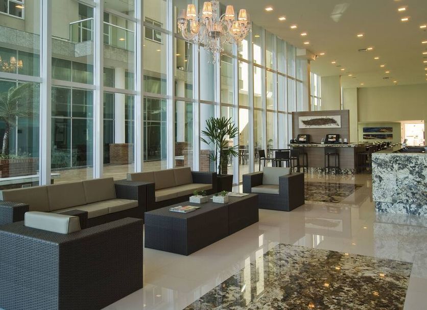 Alameda Vitória Hotel lobby in Vitória with modern seating, chandelier, and polished marble floors