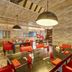 Hideaway at Royalton Punta Cana restaurant with red chairs, stone walls and pendant lighting