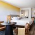 Inn at Cape Kiwanda room with king bed, round table, kitchenette and sliding door to outdoor view in Pacific City