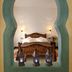 Alcoba del Rey de Sevilla bedroom seen through a turquoise Moorish arch in Seville
