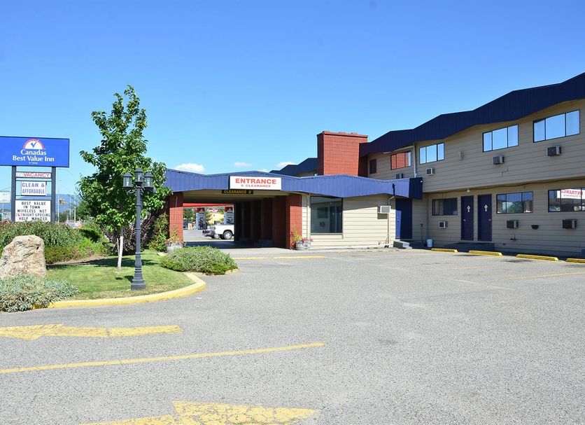 Canadas Best Value Inn Kelowna exterior with entrance drive and roadside sign in Kelowna