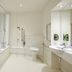 Premier Inn Thurrock East accessible bathroom in Grays with bathtub, toilet, sink and grab rails