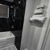Hillside Inn Pembroke bathroom with soaking tub, black tile walls, and towel rack