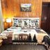 Evening Shade River Lodge & Cabins in Chimney Rock, rustic cabin bedroom with moose-themed quilt