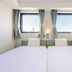 Koko Hotel Himeji Castle room with two twin beds and city-view windows in Himeji