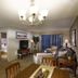 Oakwood Falls Church, Falls Church: living room with sofa, TV, dining table, and sliding doors to a balcony