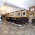Medicine Hat Suites lobby in Medicine Hat with stone fireplace, leather seating, and tiled floors