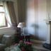 Aisleigh Guest House in Leitrim guest room with fireplace, round mirror, window and floral arrangement