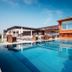 Genusshotel Riegersburg pool terrace with loungers and modern wood-clad building in Riegersburg