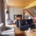 Auberge du Lac-a-l'Eau-Claire in Saint-Alexis-des-Monts: cozy lodge lounge with fireplace, leather sofas and dining area