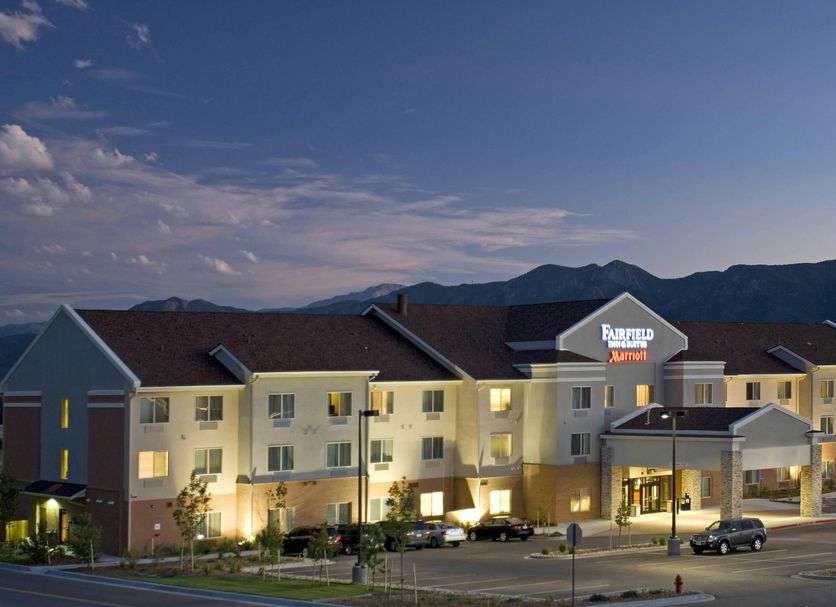 Fairfield Inn & Suites by Marriott Colorado Springs North/Air Force Academy exterior at dusk with mountain backdrop