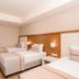 Venosa Beach Resort And Spa Didim twin room with three beds and wood-paneled headboard