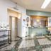 Tendo Central Hotel in Tendō lobby with front desk, mint-green sofa, and tiled floor