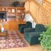 Americas Best Value Inn Annandale lobby seating area with wooden shelves, TV, chairs and staircase