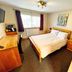 The Carrington Arms, Newport Pagnell bedroom with double bed, desk and window with curtains