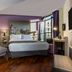 Leonardo Hotel Madrid City Center room with king bed, balcony city view, armchair and desk in Madrid