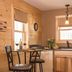 Sterling Ridge Resort in Jeffersonville kitchen with bistro table, wine glasses, sink, and wood-paneled walls