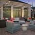 Hilton Garden Inn Tallahassee Central patio with string lights, lounge seating and fire pit at dusk