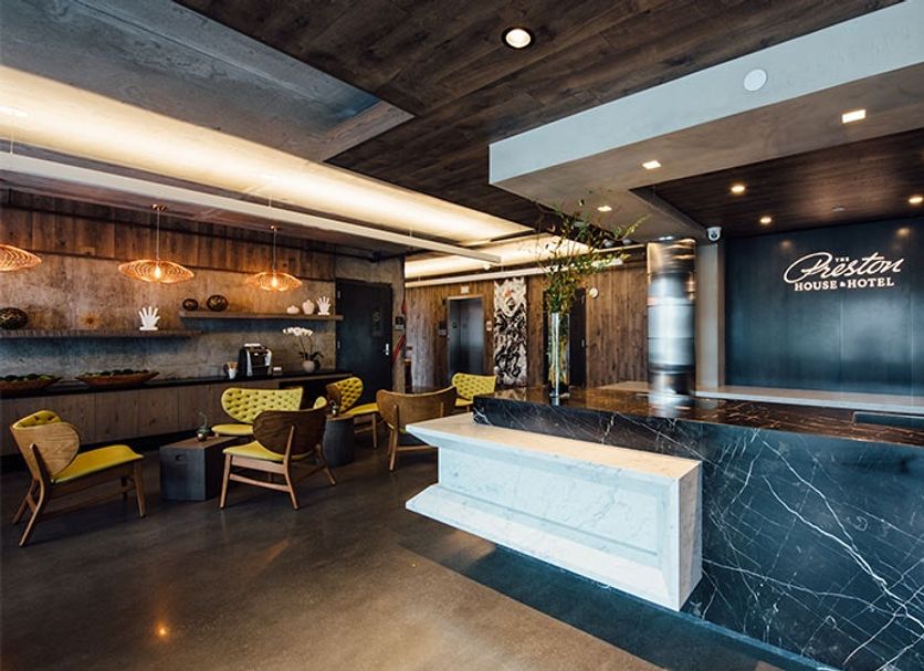 The Preston House and Hotel lobby in Riverhead with marble reception desk, seating area and bar