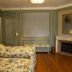 Manoir de Beaumarchais room in Les Chapelles-Bourbon with floral beds, fireplace and wood floors