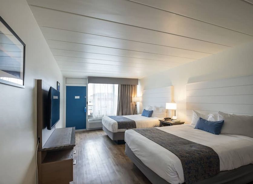 The Forum Ocean City guest room with two beds, TV, and window view