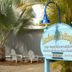 Seahorse Cottages on Sanibel sign by palms and outdoor seating area in Sanibel