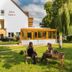 Hotel Knorre in Meissen with garden seating, a glass-enclosed terrace and trees on the lawn