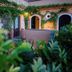 Marulivo Hotel in Pisciotta courtyard with ivy-covered walls, arched doors, and lush greenery