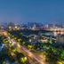New Century Grand Hotel Kaifeng city skyline view at night with lit roads and riverfront